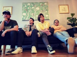Curse Words band members sitting on a sofa